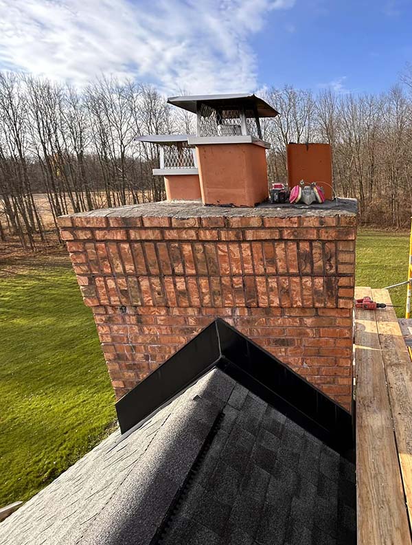 A chimney cap is a protective cover crafted from concrete or masonry that shields the upper opening of your chimney
